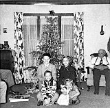 Christmas at Emil Escher's home.  Emil, right, Bill Escher, Mary Klassy and in front, Donald and Susan Klassy.